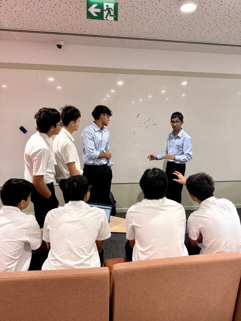 Harihar working through a problem with Applied Maths Club members